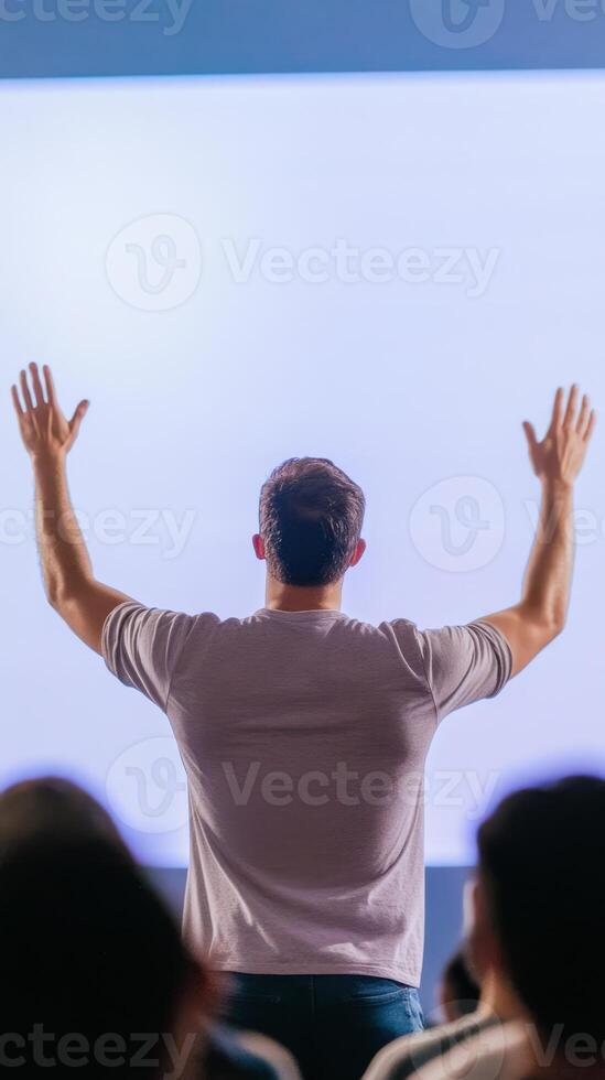 A person confidently presents a mobile app user interface focused on real estate to an engaged audience in a contemporary setting photo
