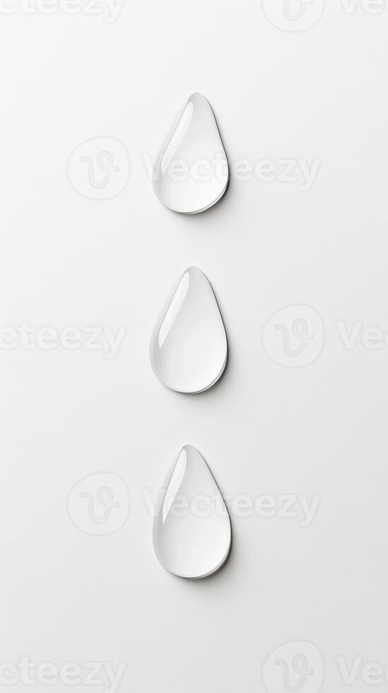 Three water droplets rest on a pristine white surface, reflecting light and emphasizing their clarity. The arrangement conveys a sense of tranquility photo