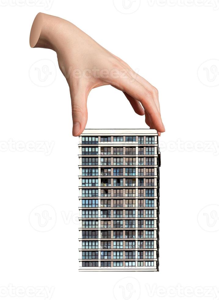 Hand holding a small model of a modern house or apartment, ownership and real estate investment. photo