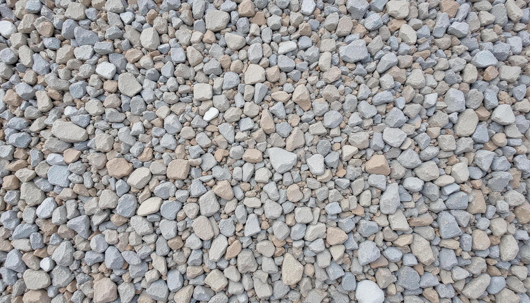 The texture of coarse gravel, showing the angular shapes and rough surfaces of the stones. photo