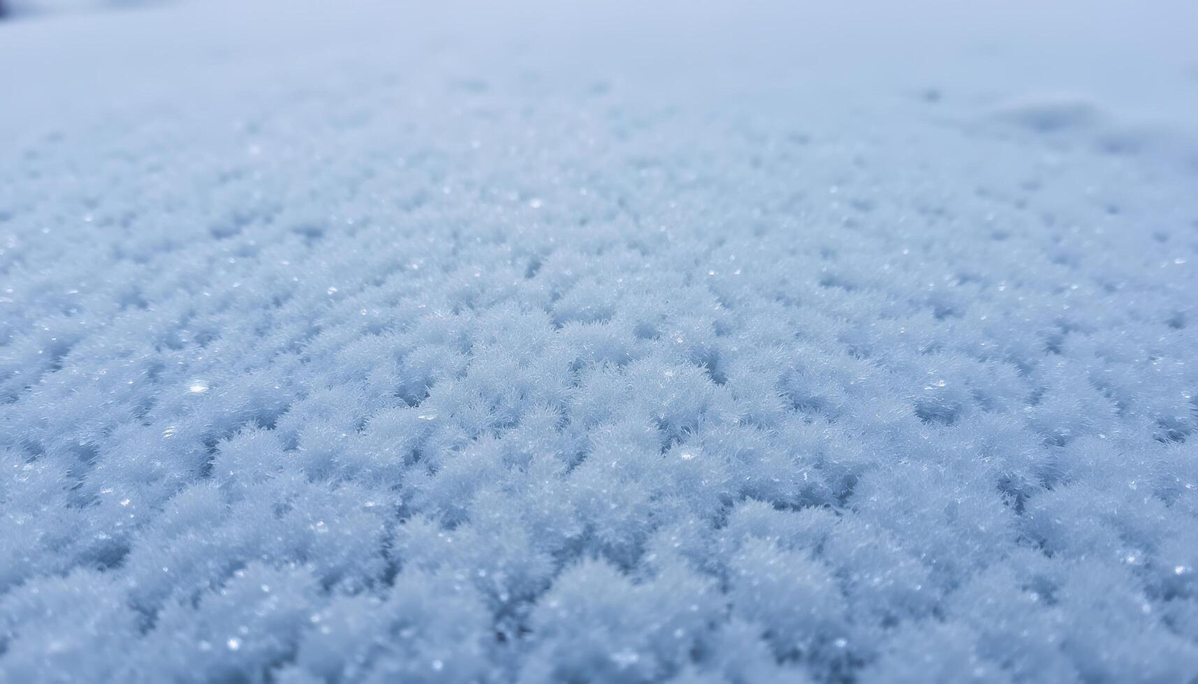 A close up of ice crystals forming on a frozen surface, showcasing their intricate patterns and frosty texture. photo