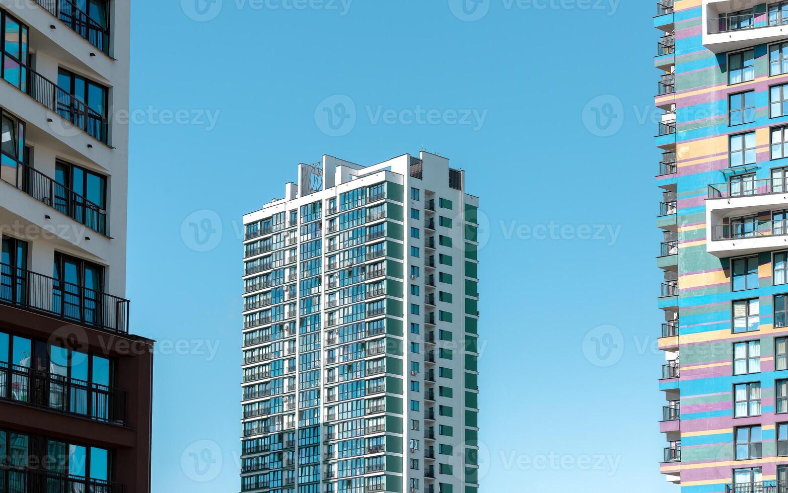 Building with modern architecture. Tall condominium with window facade and multi story design in photo