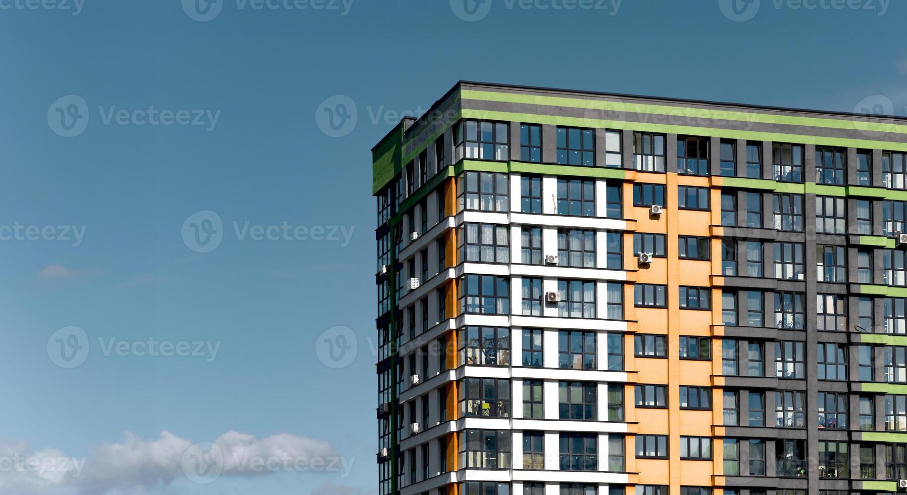 Building with modern architecture. High rise condominium with clear blue sky, sunny downtown photo