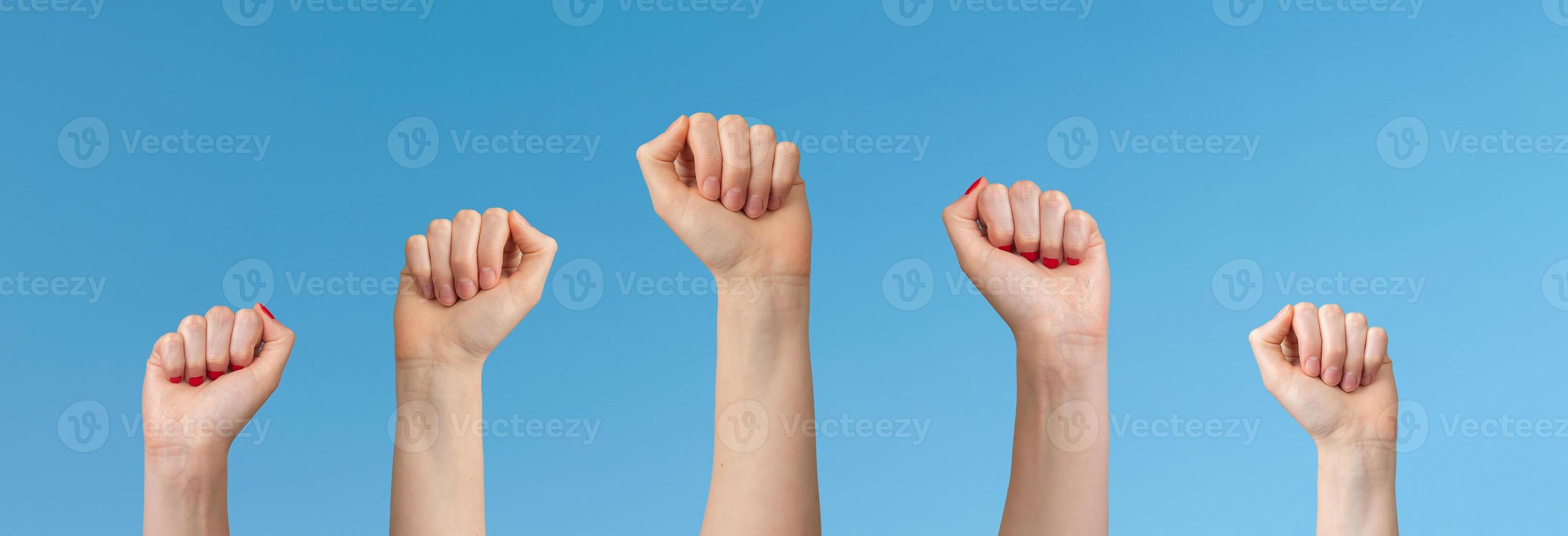 Fist raised up. Woman showing strength, power, courage, freedom, and determination in protest, photo