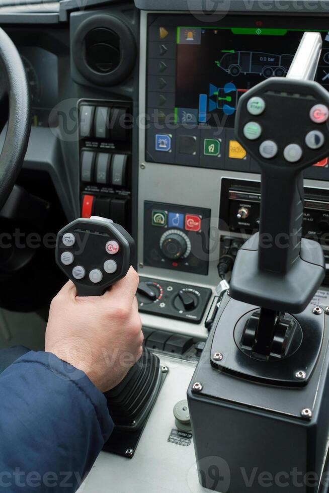 Control system used in heavy machinery during operation at a construction site showcasing the interface and joysticks for precise maneuvering of equipment photo