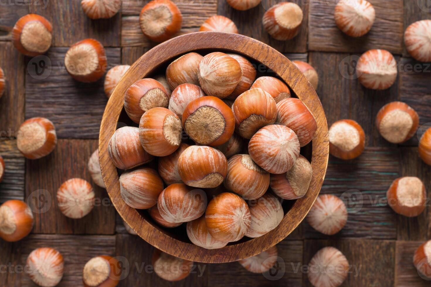 shelled hazelnut in wooden bowl, top view. photo