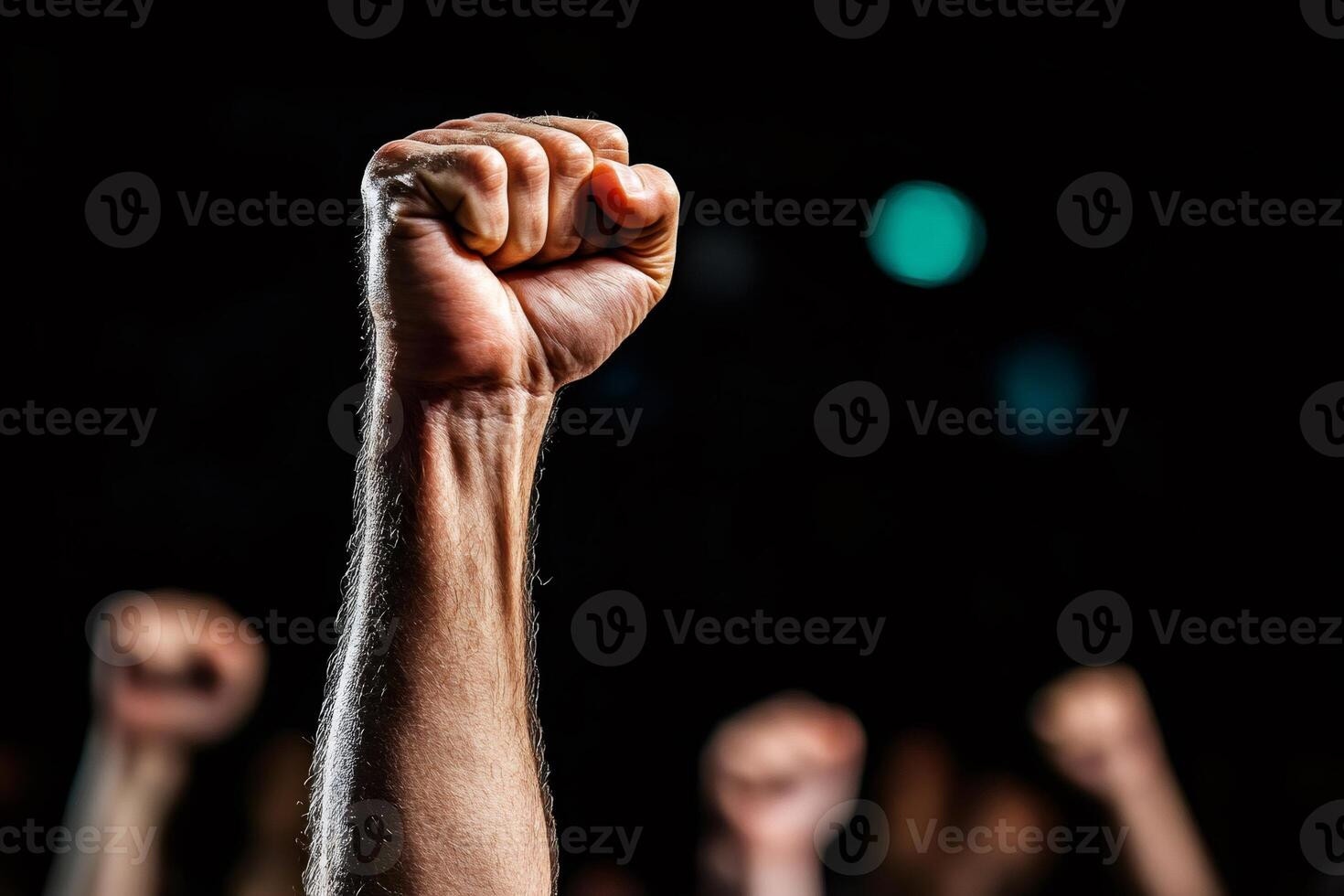 Raised fist symbolizing strength and protest in a crowd photo
