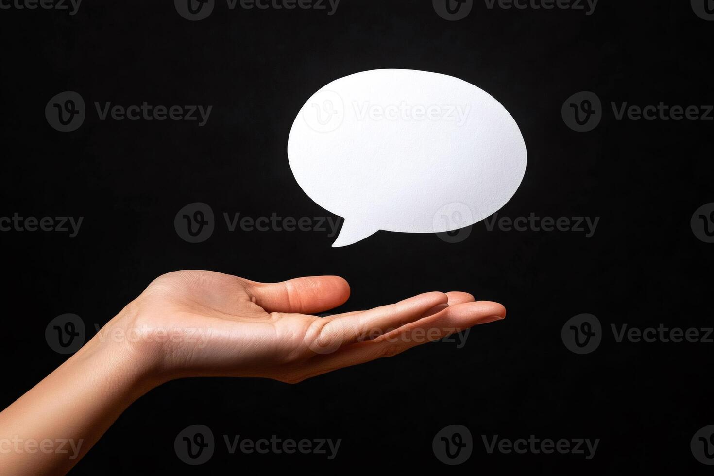 Hand holding speech bubble on black background, communication and social media concept photo