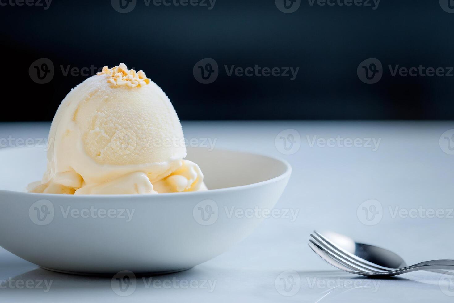 Scoop of vanilla ice cream melting in bowl with toasted almond flakes photo