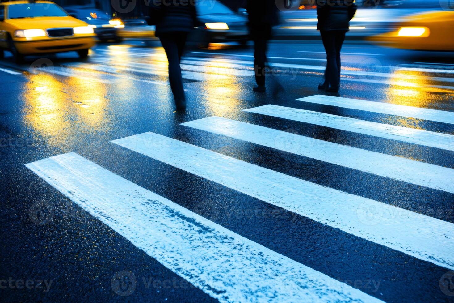People crossing the street at a crosswalk on a rainy night photo