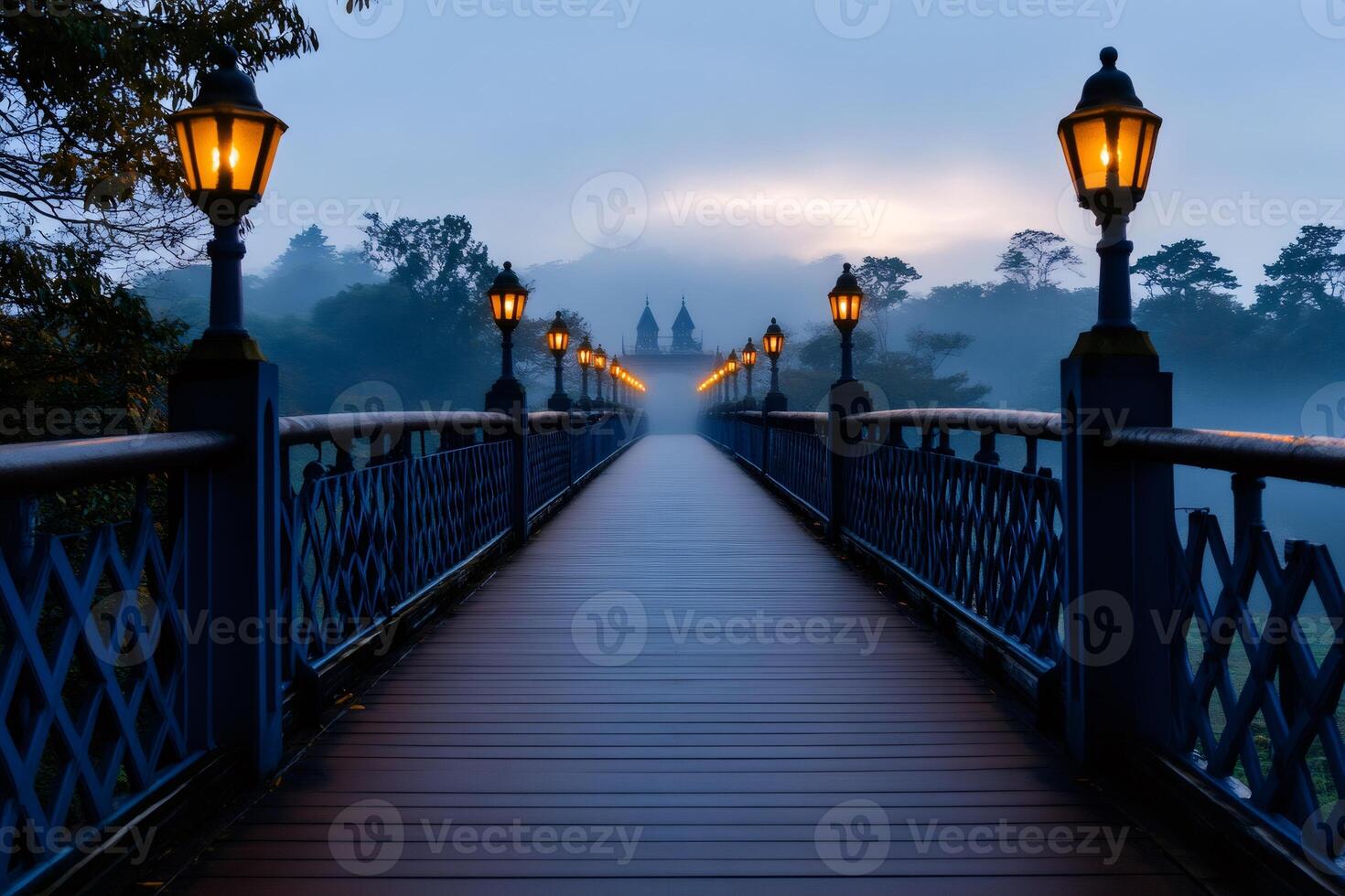Wooden bridge with illuminated street lamps leading to a temple in the fog at dawn photo