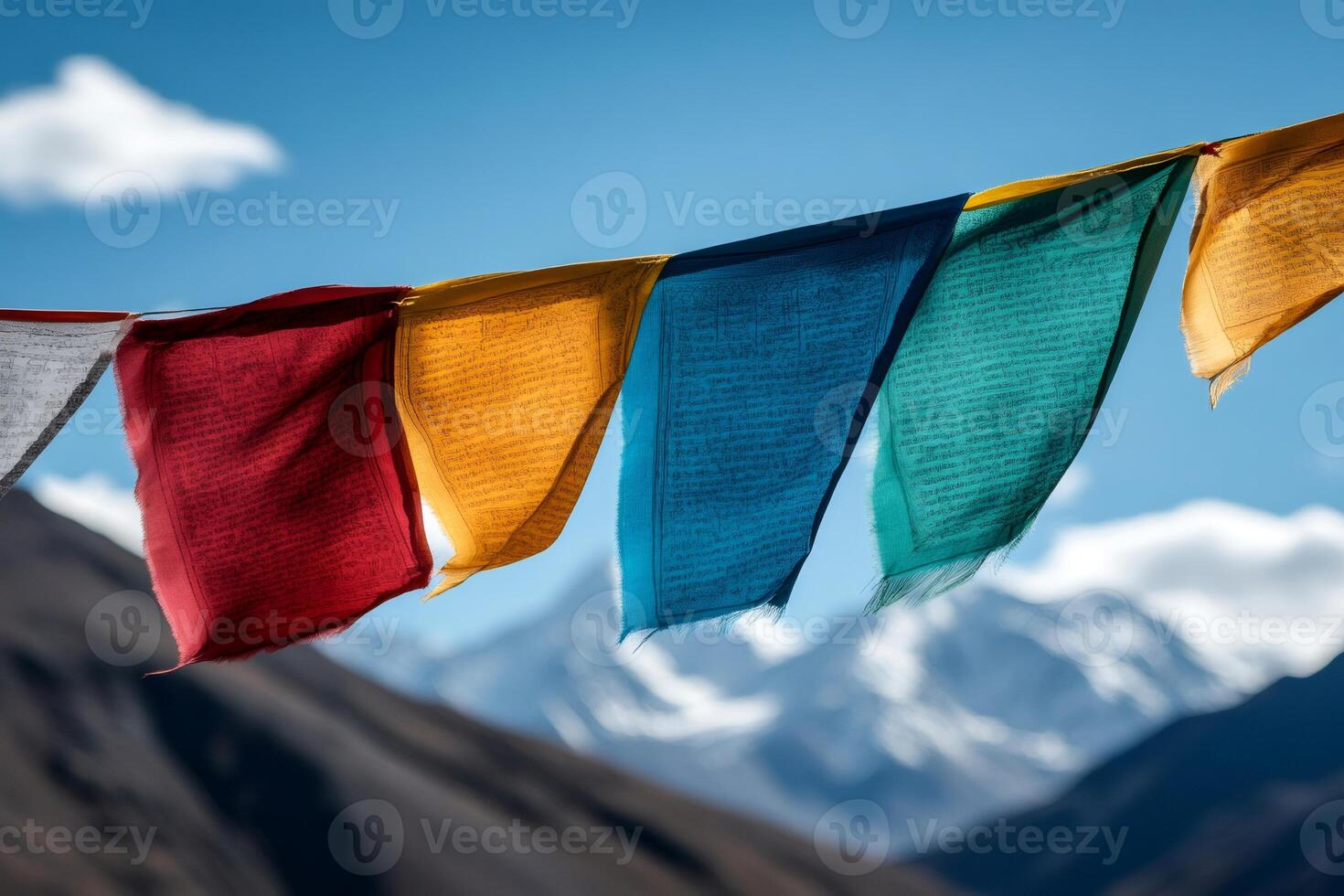 Colorful prayer flags waving in the wind with himalayas mountains in background photo