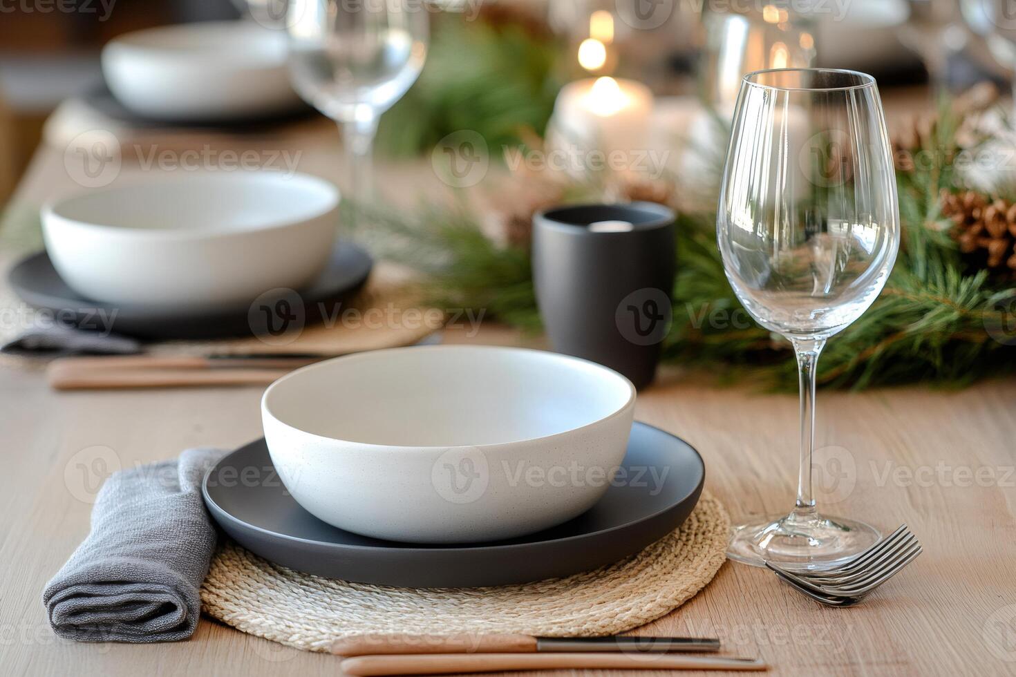 Christmas table setting decorated with candles and evergreen branches photo