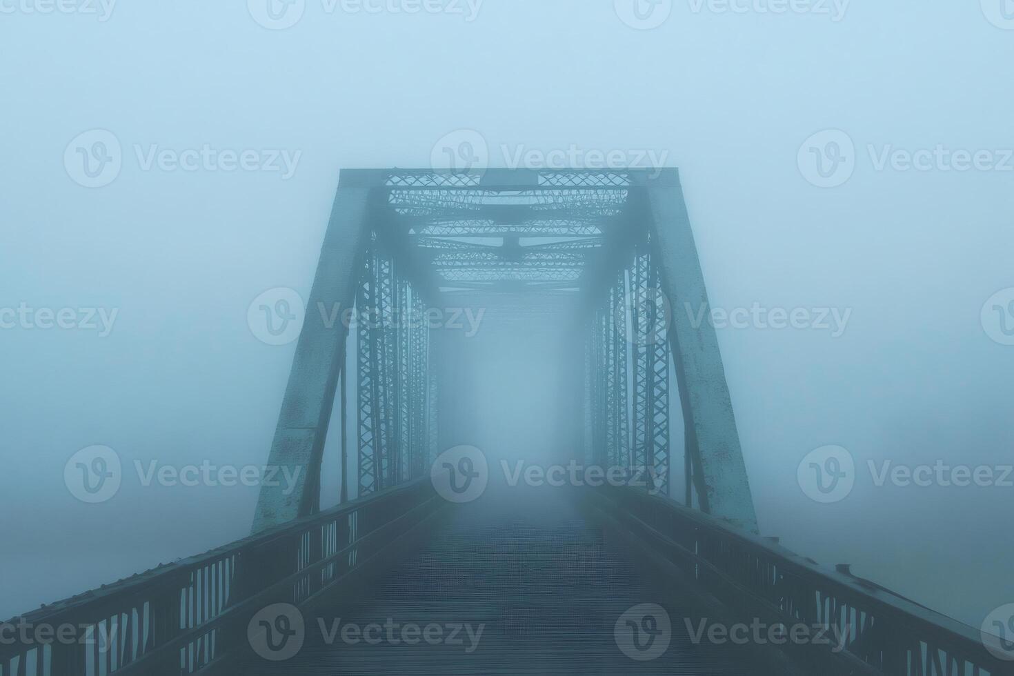 Old metal bridge disappearing into heavy fog on a gloomy day photo
