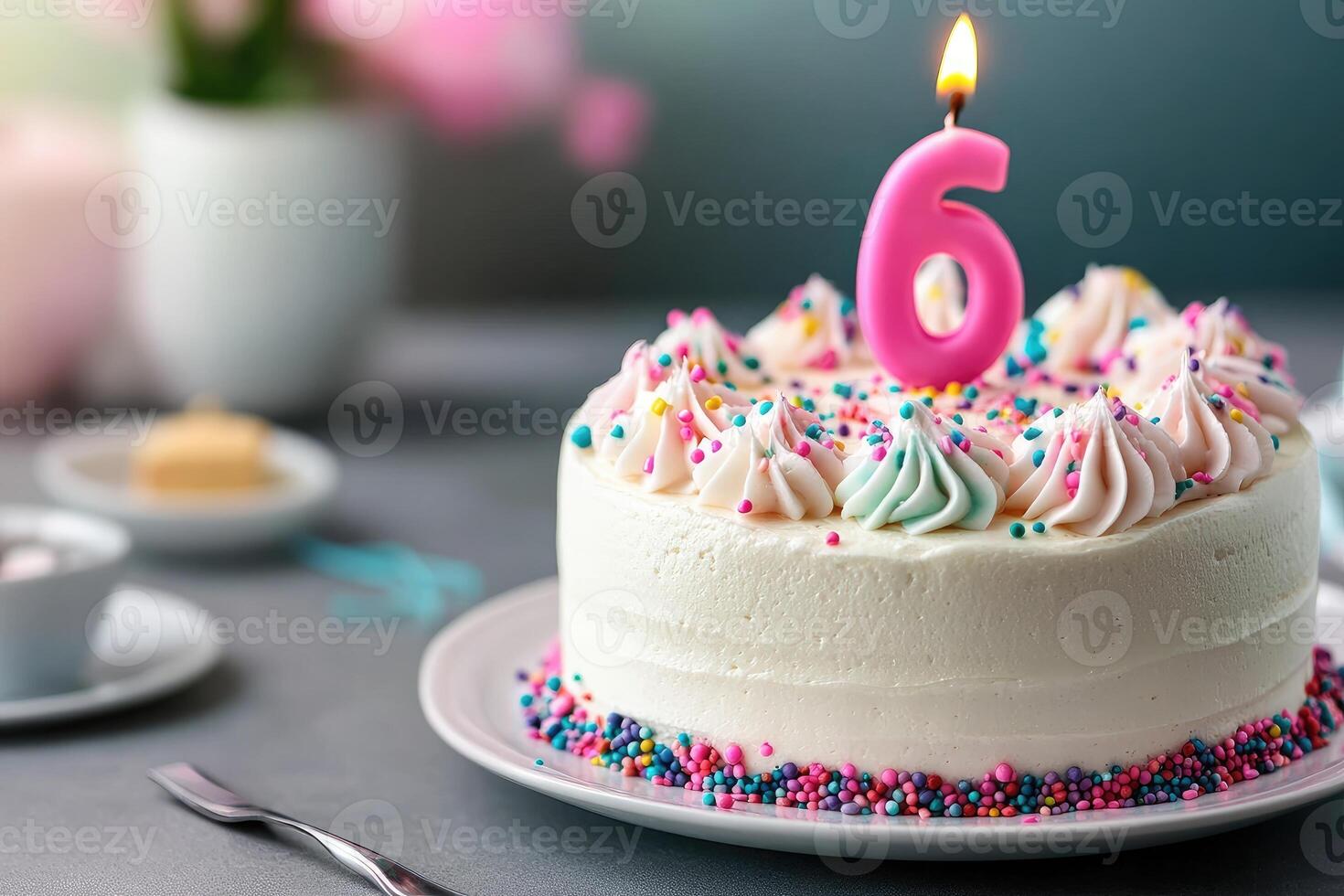 Delicious cake celebrating a sixth birthday with lit candle and colorful sprinkles photo