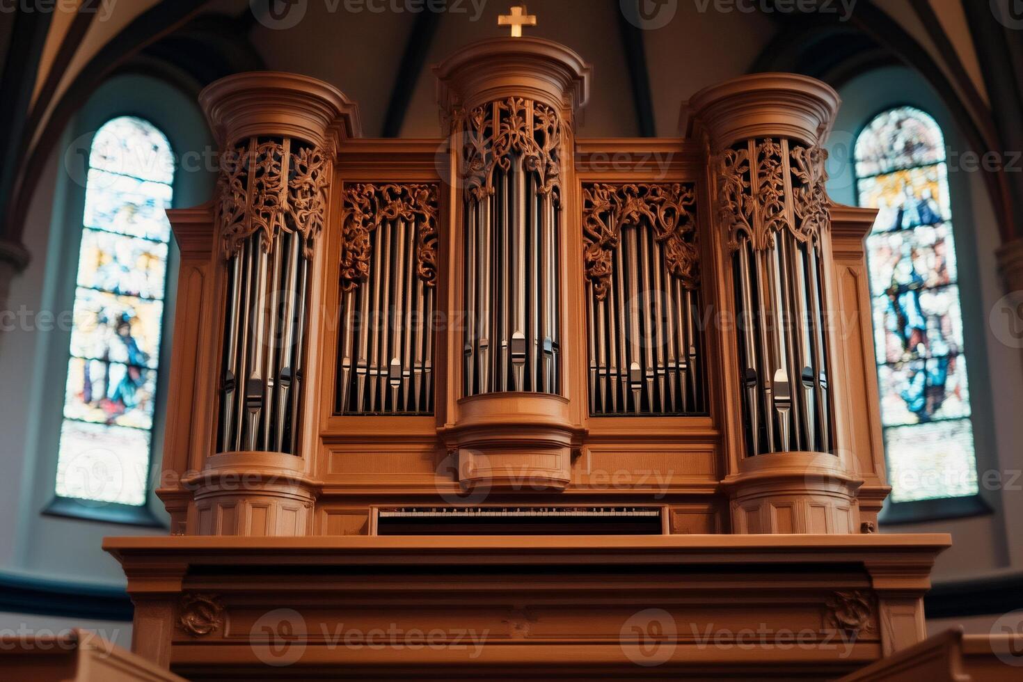Majestic pipe organ standing in church, displaying intricate carvings and metallic pipes photo
