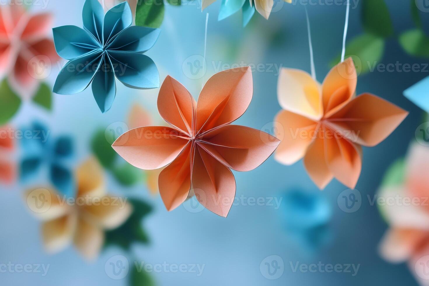 Colorful origami flowers hanging on a string, creating a beautiful decoration photo