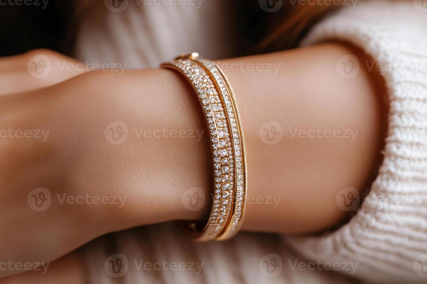 Woman wearing luxury golden diamond bracelets, showing jewelry and elegance photo