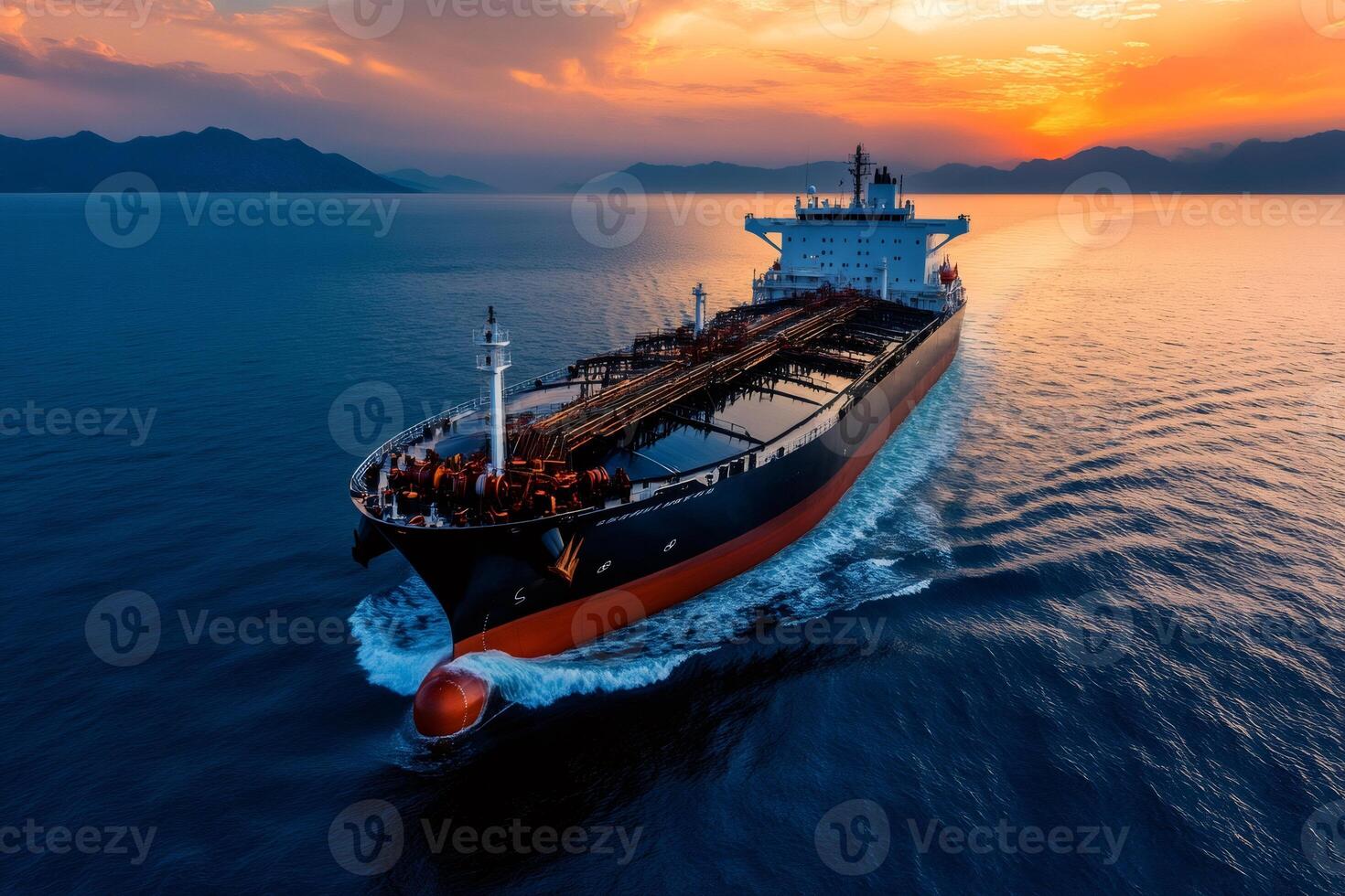 Large crude oil tanker ship sailing on the ocean at sunset photo