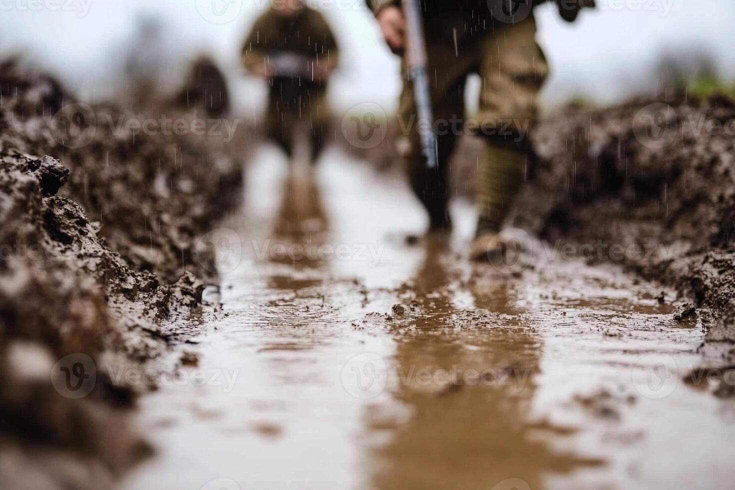 Two soldiers walking through a muddy field photo