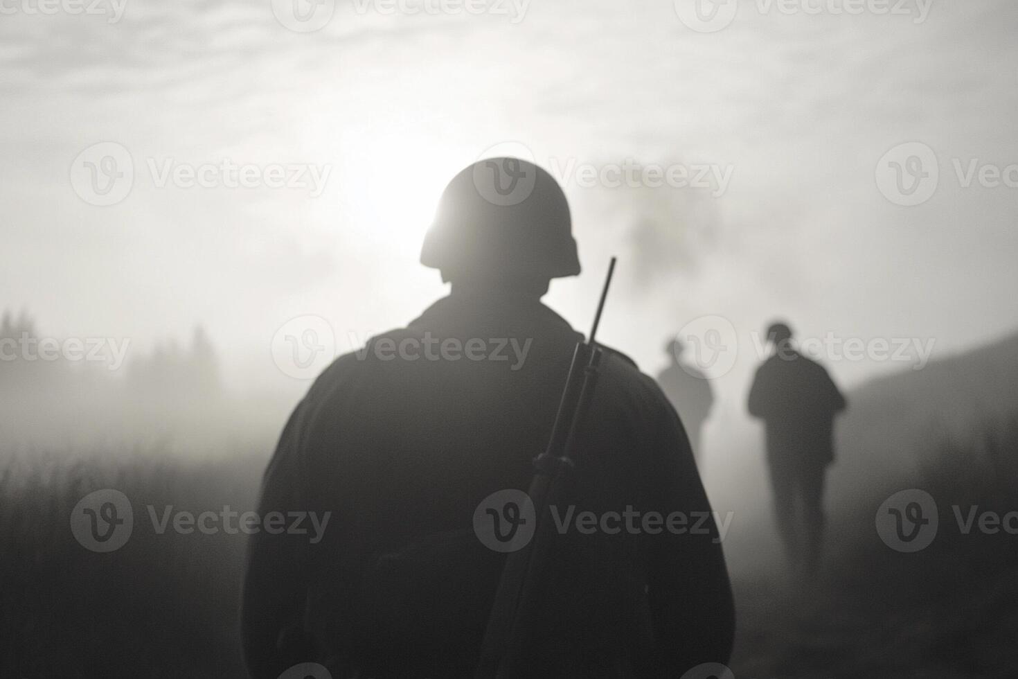 A man in a military uniform is walking through the fog photo