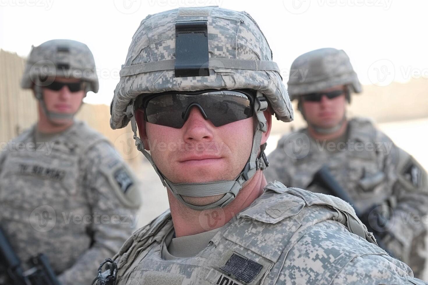 A soldier wearing sunglasses and a helmet photo