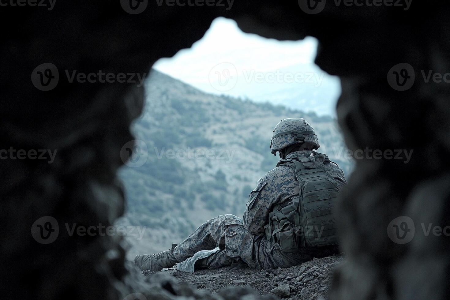 A soldier sitting in a cave photo