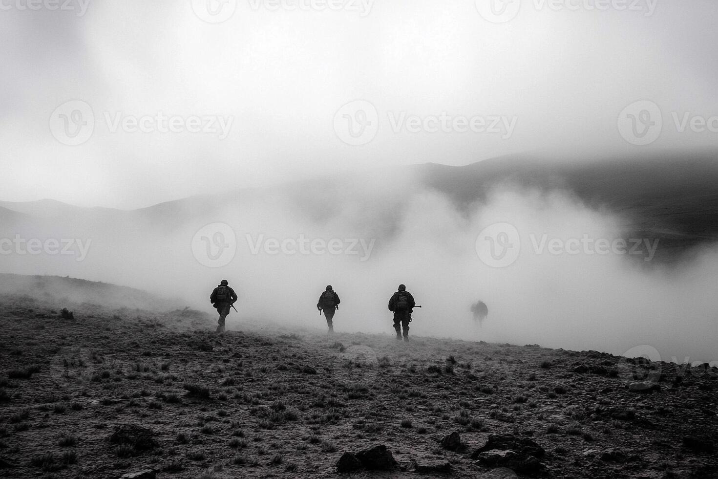 Three people walking in the fog on a mountain photo