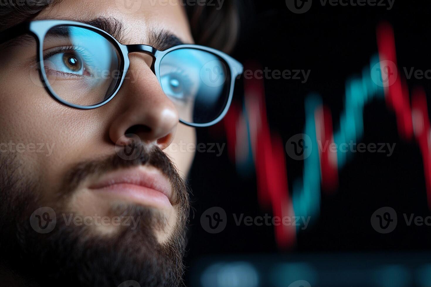 A man with glasses and a beard is looking at a stock chart photo