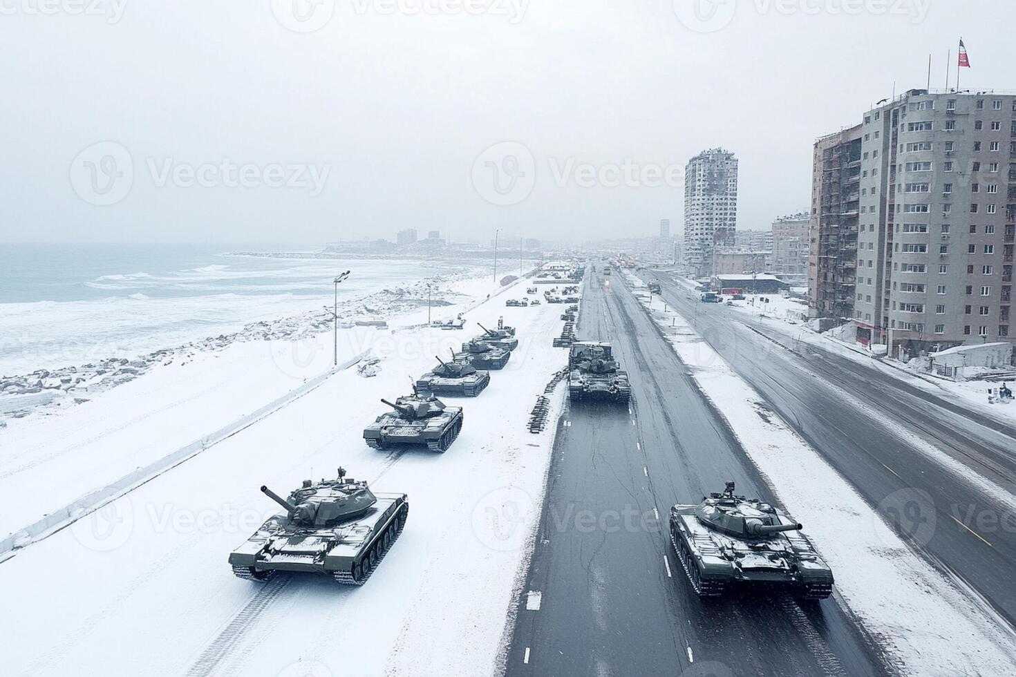 Tanks are lined up on the road in front of the ocean photo