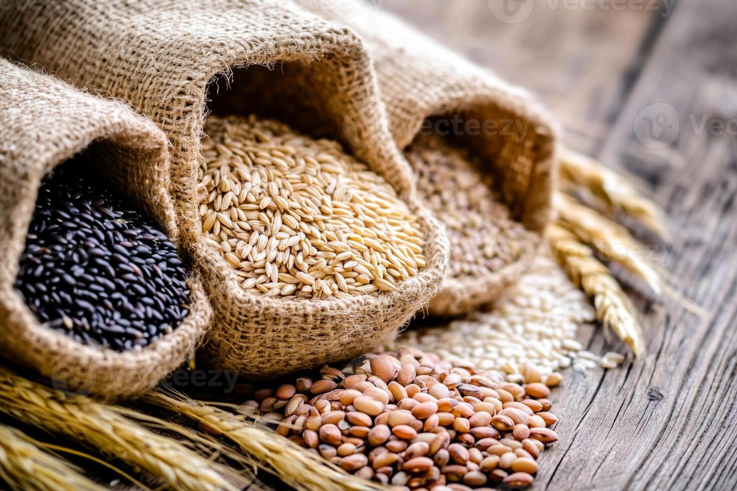 Wheat, rice and other grains in sacks on wooden table photo