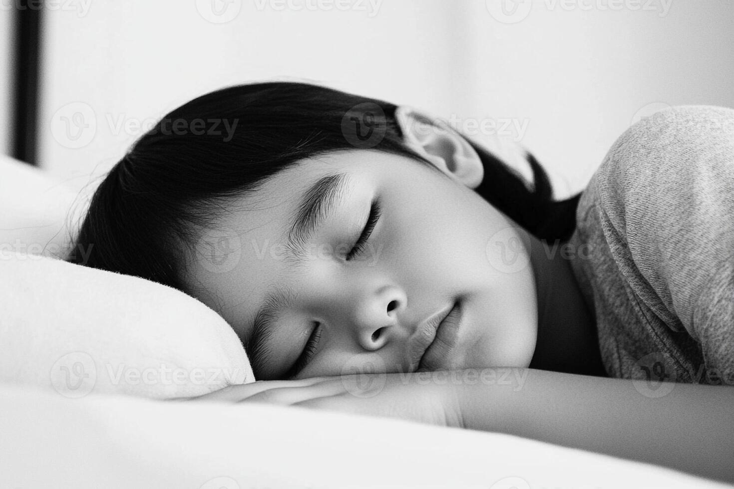 A young child sleeping on a bed photo