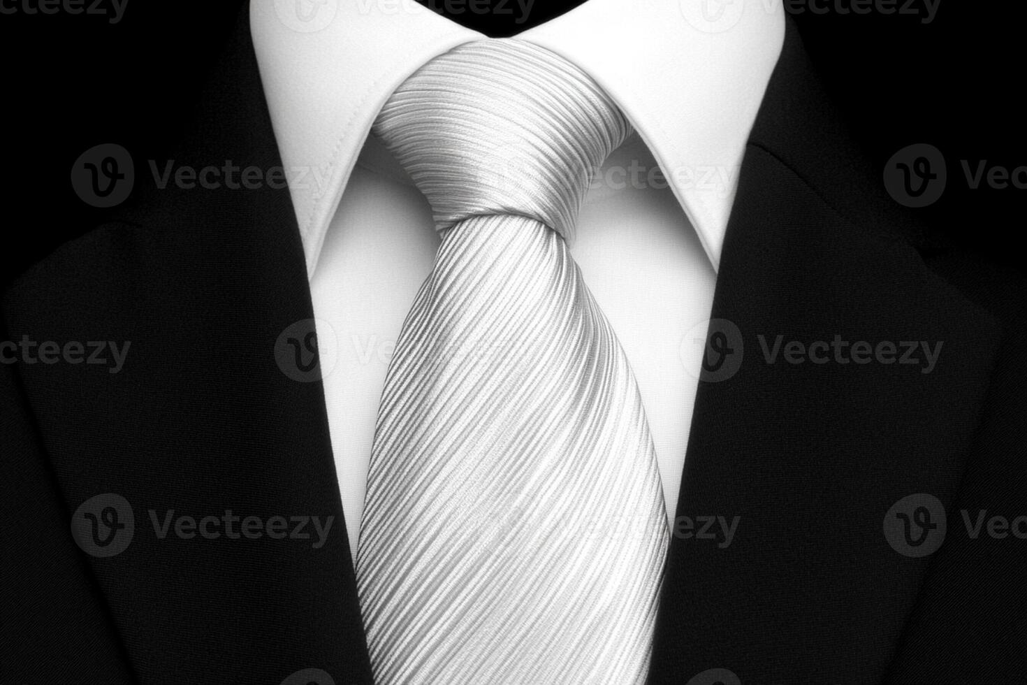 A white tie and black suit with a white shirt photo