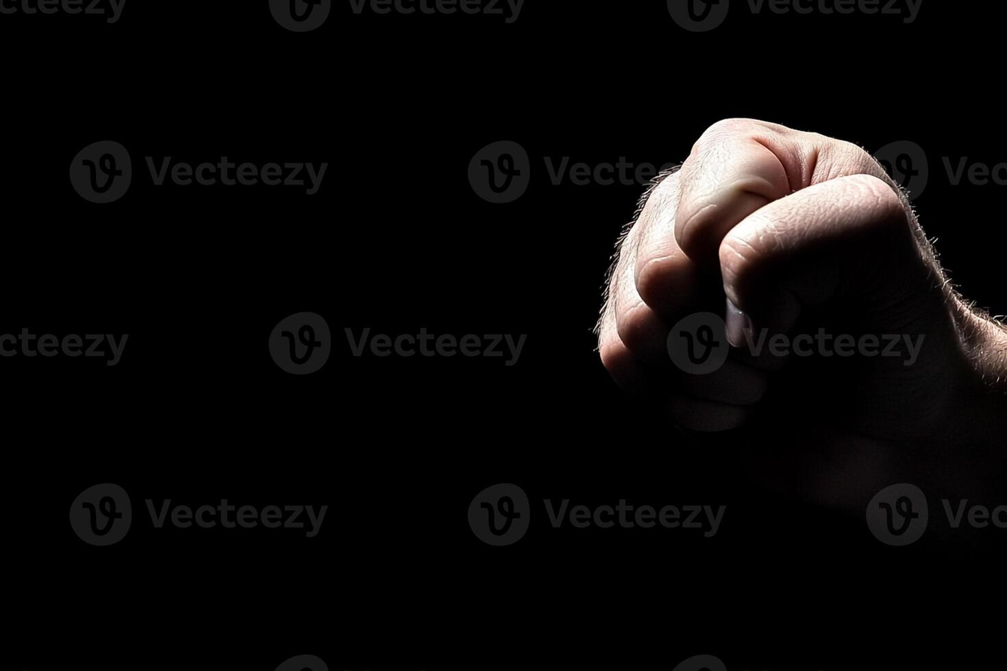A person's hand is pointing up in the dark photo