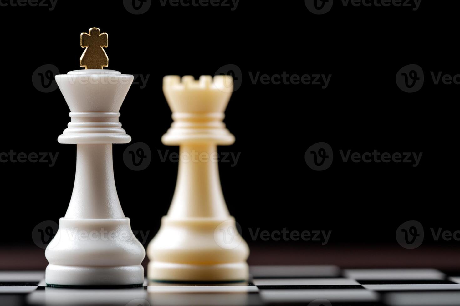 Two white and one black chess pieces on a black background photo