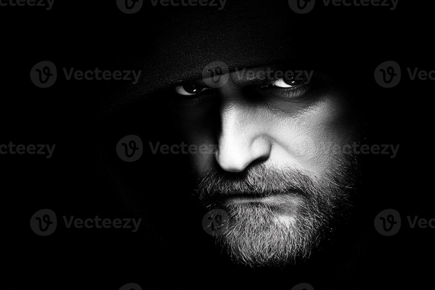 A man with a hoodie on and a beard photo