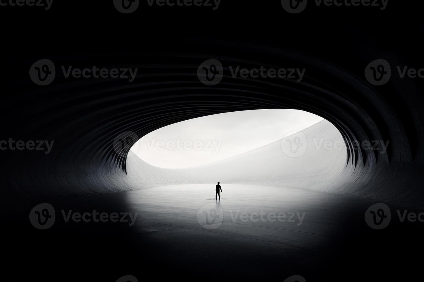 A person standing in the middle of a large tunnel photo