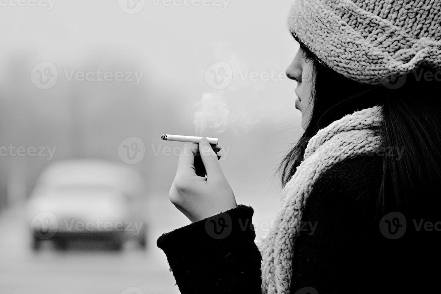 A woman smoking a cigarette on the street photo