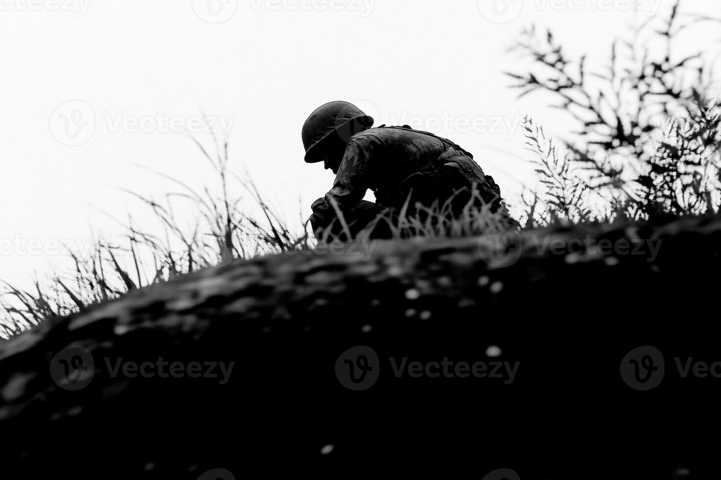A soldier is sitting on top of a hill photo