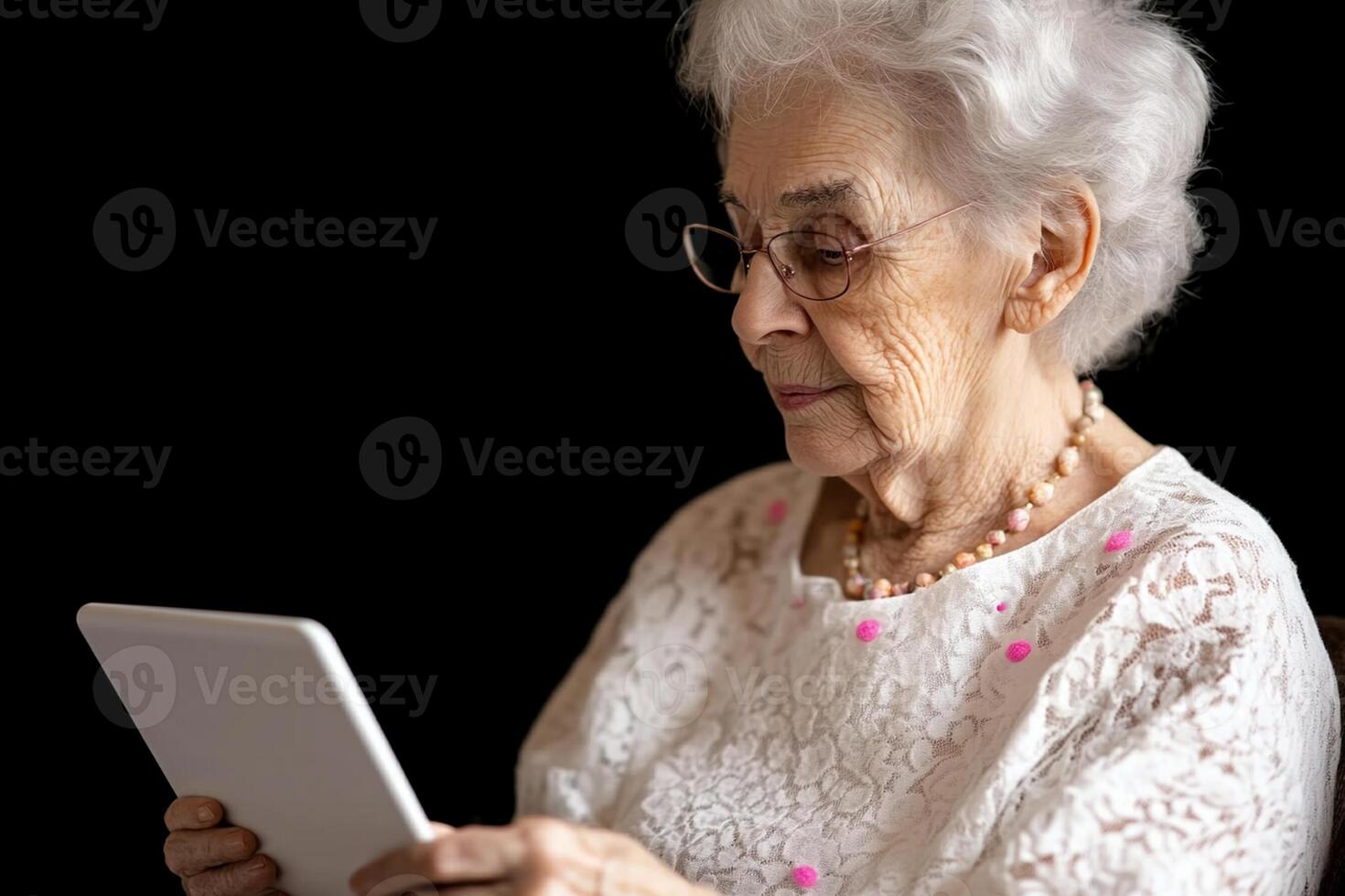 An older woman is using a tablet computer photo