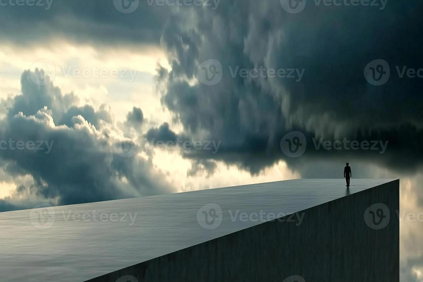 A man stands on a ledge looking at the sky photo