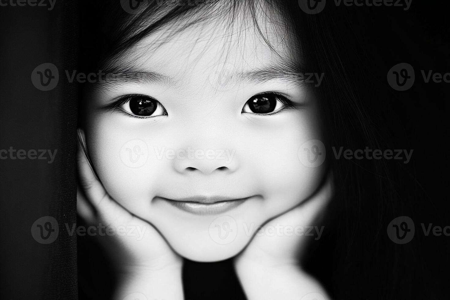 A little girl is smiling in black and white photo