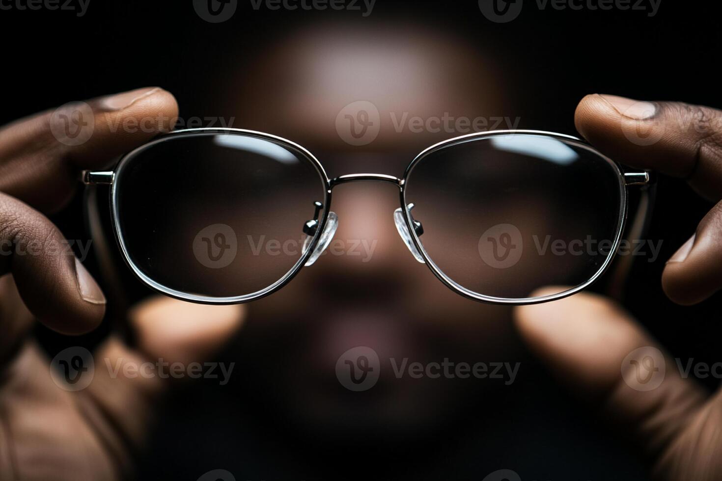 A person holding up a pair of glasses photo