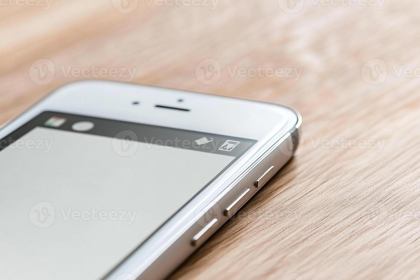 An iphone is sitting on a wooden table photo