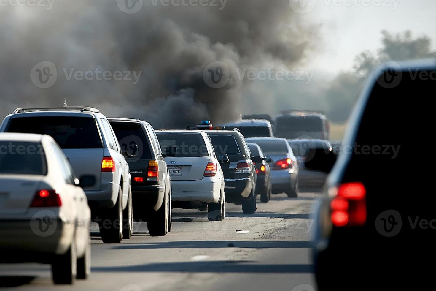 Smoke billowing from a car on the highway photo