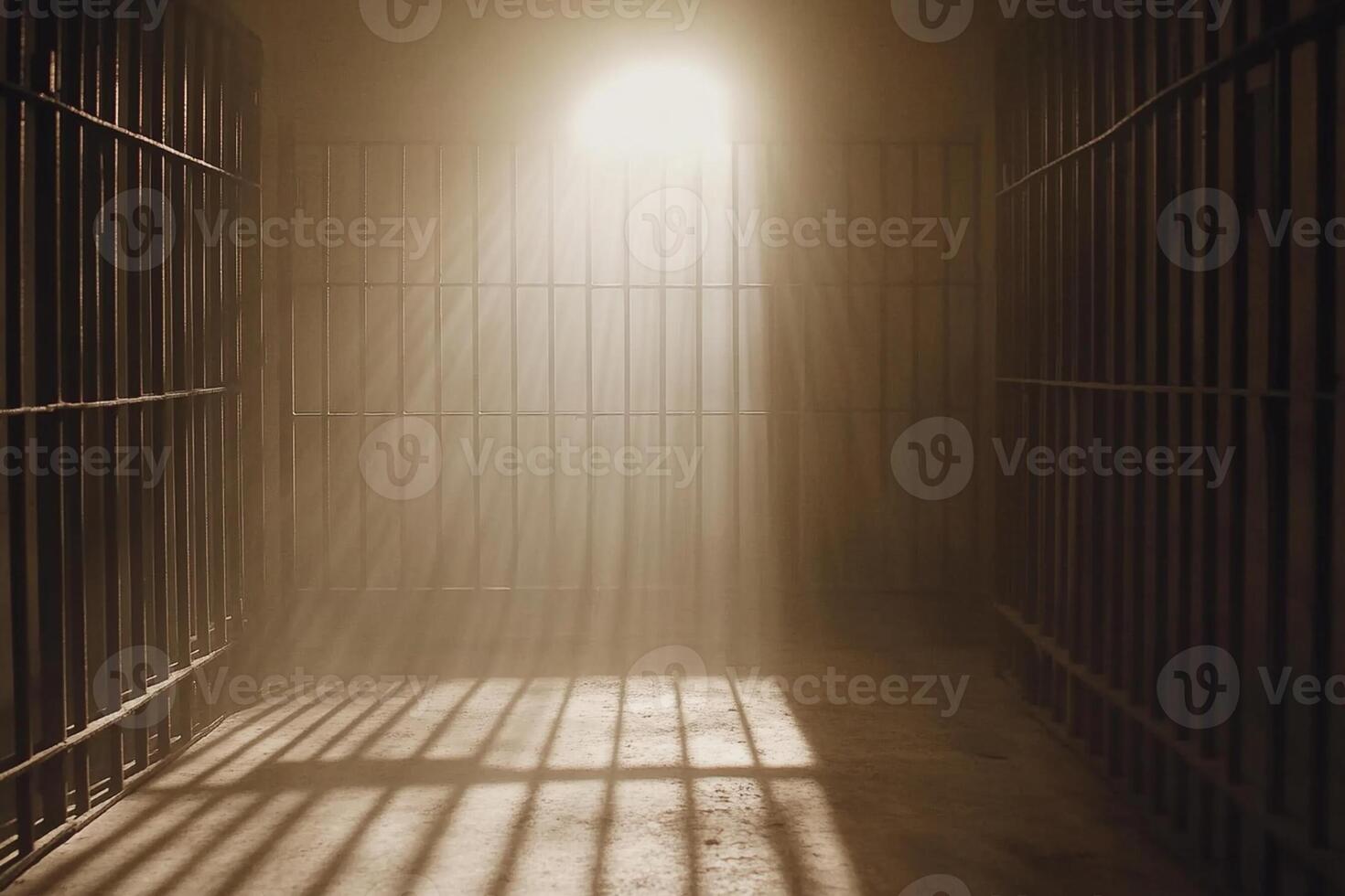 A prison cell with a light shining through the bars photo