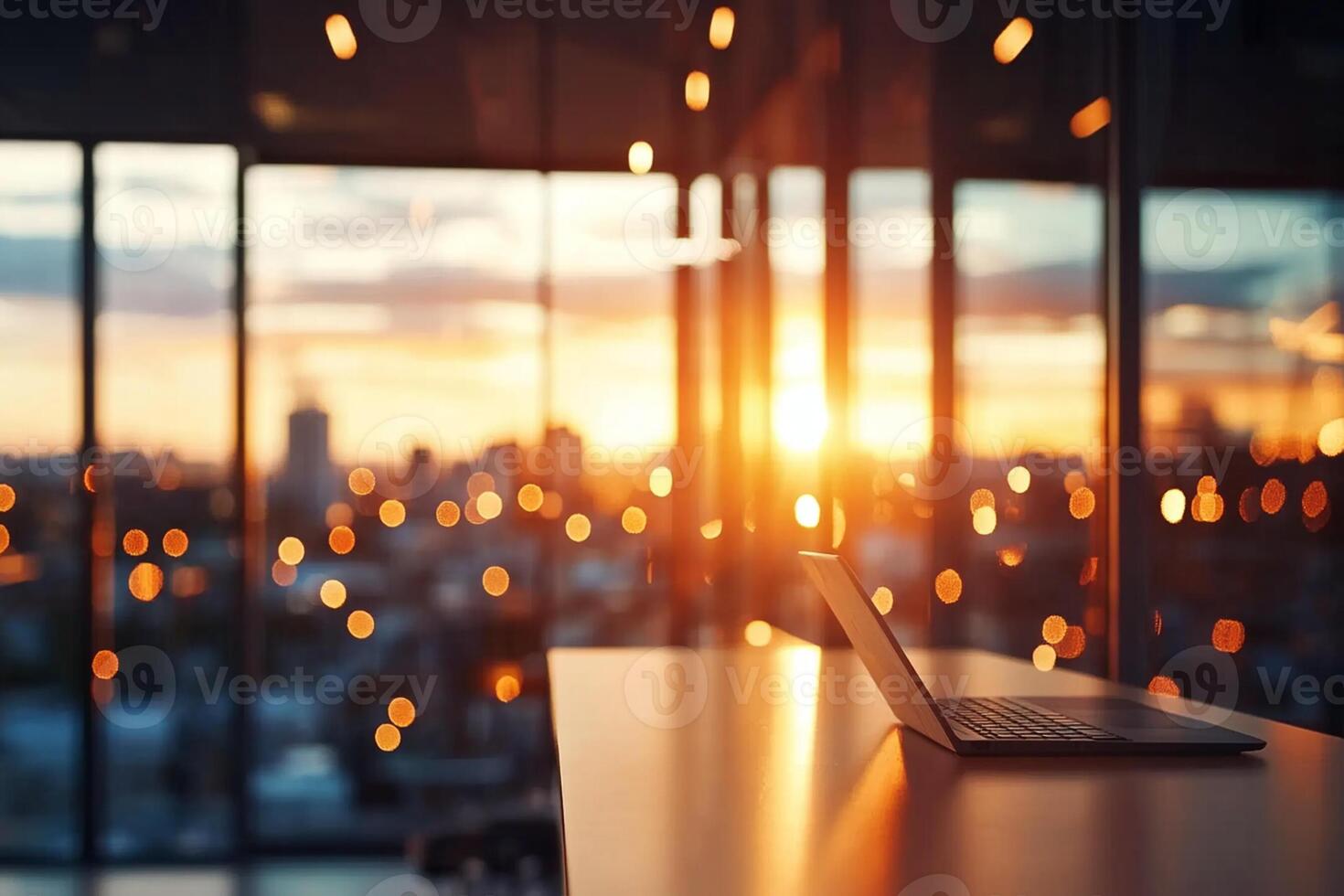 A laptop sitting on a table in front of a window with a cityscape in the background photo