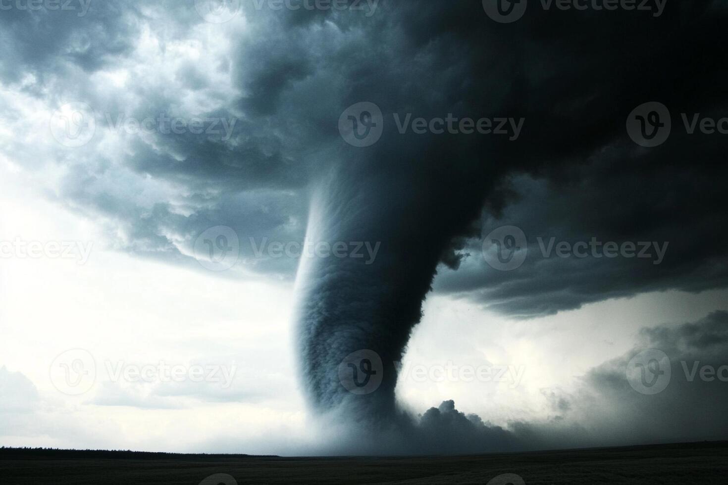 A tornado is seen in the sky over a field photo