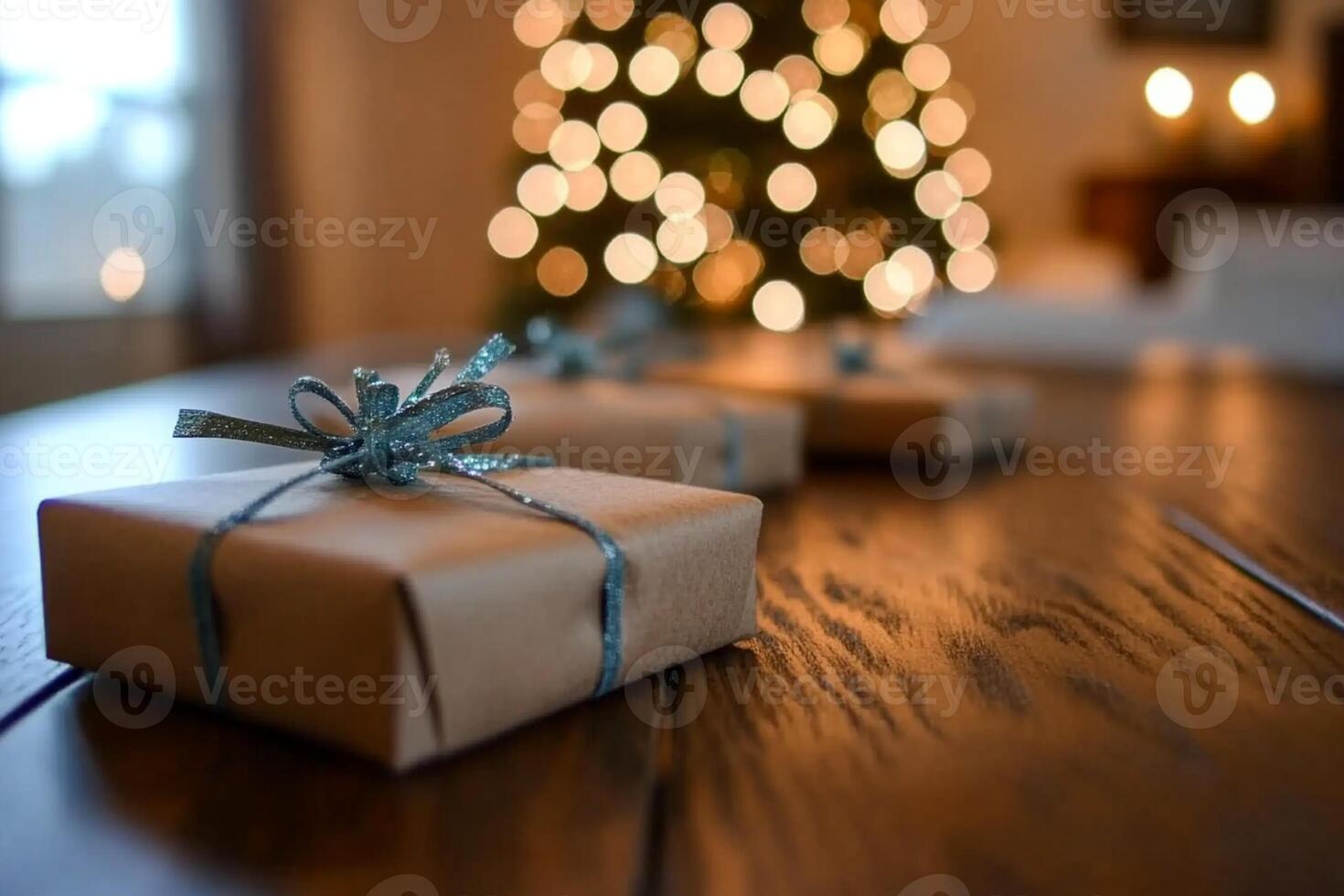 Gift boxes on a table in front of a christmas tree photo