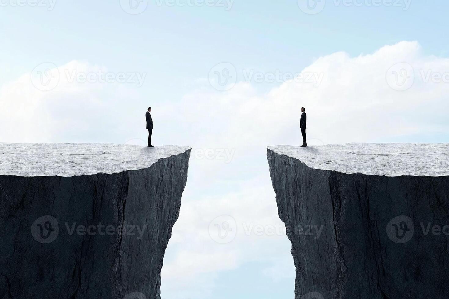 Two people standing on the edge of a cliff photo